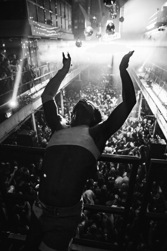 black and white photo of person at busy nightclub